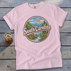 Pink t-shirt with circular graphic of South Carolina landscape featuring a deer and river.