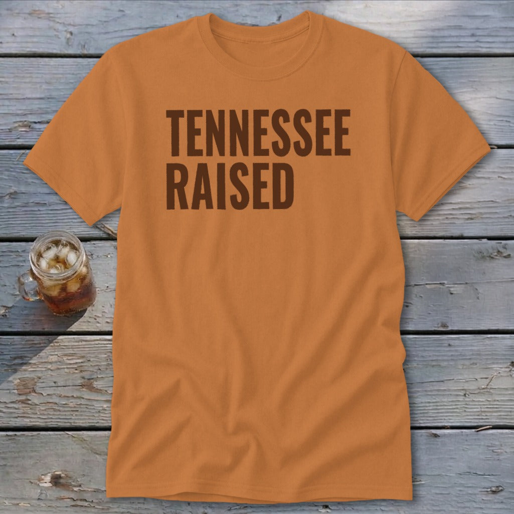 Orange t-shirt with "TENNESSEE RAISED" text in brown font.