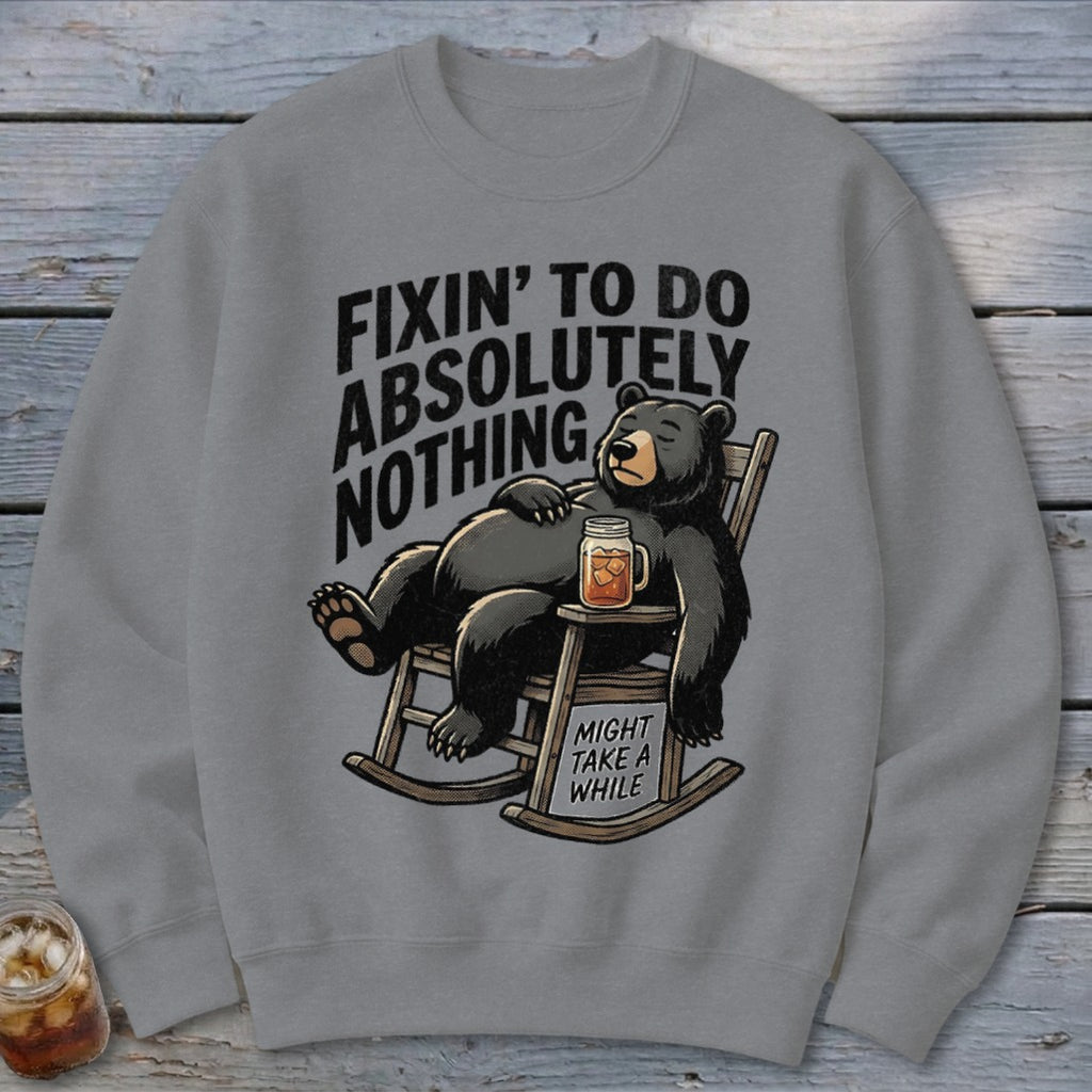 Gray crewneck sweatshirt featuring a graphic of a black bear relaxing in a rocking chair.