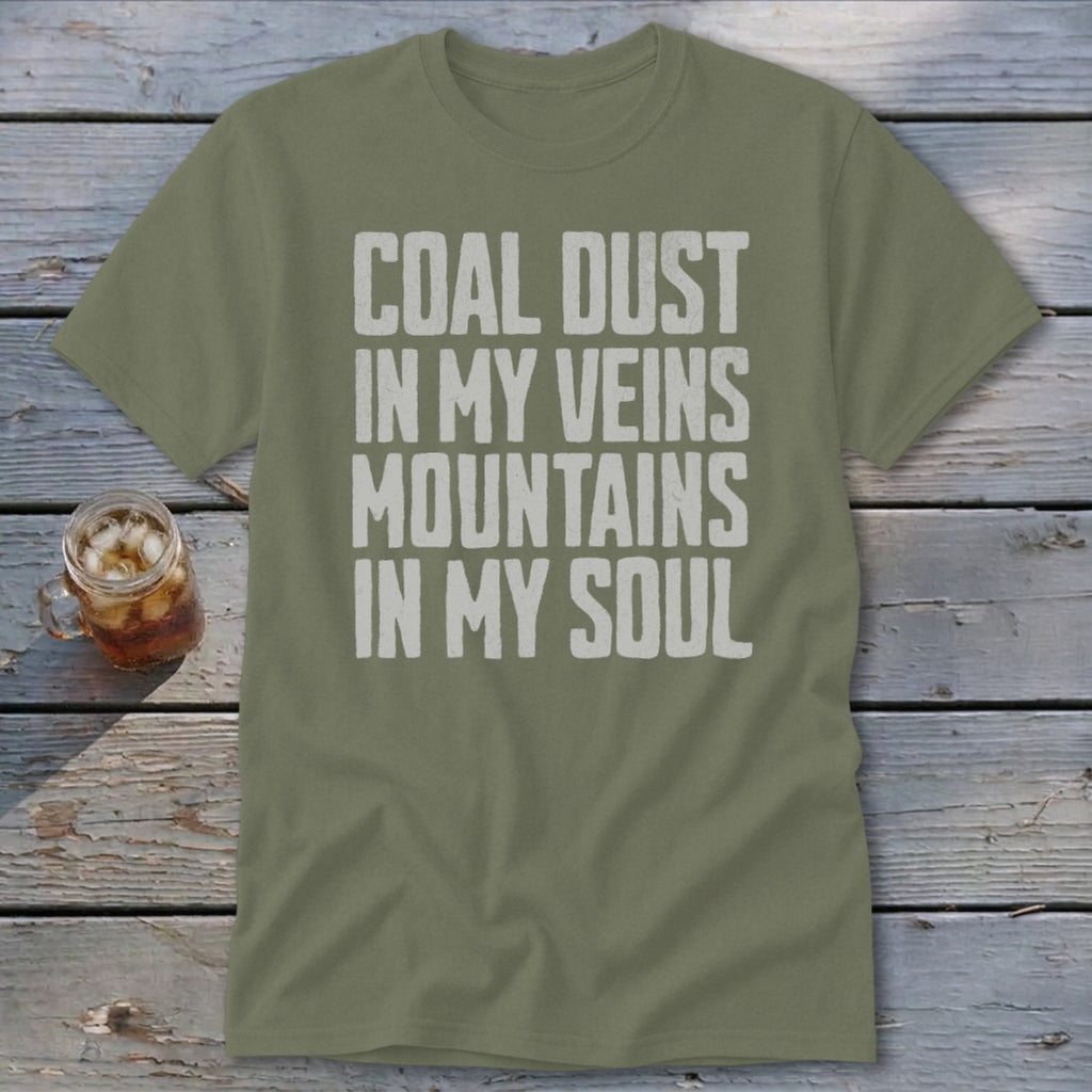 Olive green t-shirt with distressed white text reading COAL DUST IN MY VEINS MOUNTAINS IN MY SOUL.