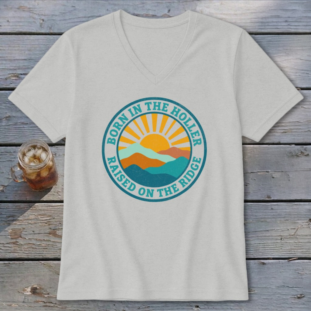 Light gray V-neck t-shirt featuring a circular graphic with mountains, a rising sun, and text.