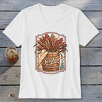 White v-neck t-shirt with a graphic of sorghum stalks overflowing from a wooden barrel.