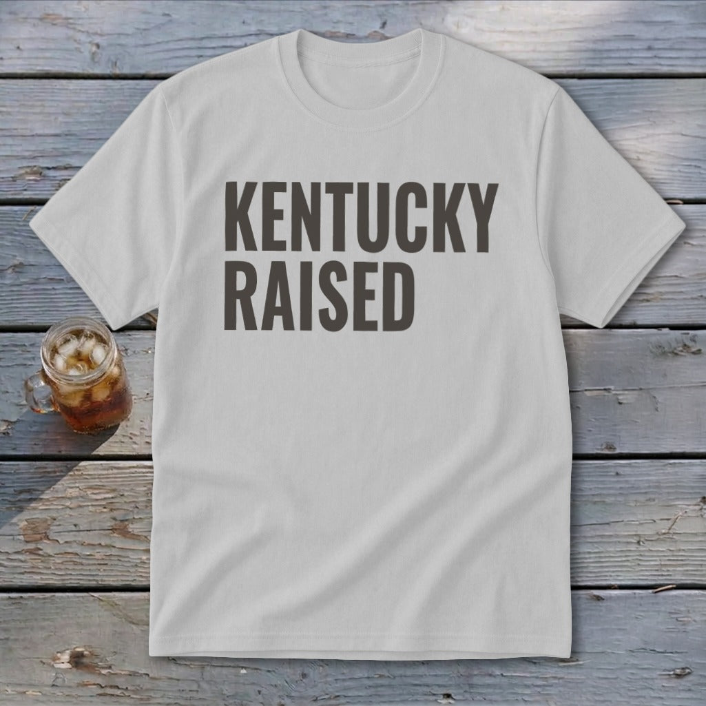 White t-shirt with dark gray text reading "KENTUCKY RAISED."