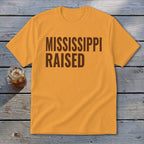 Orange t-shirt with "MISSISSIPPI RAISED" text in dark brown.