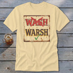 A light yellow t-shirt featuring a distressed sign with the text WASH crossed out in red and WARSH checked in green.