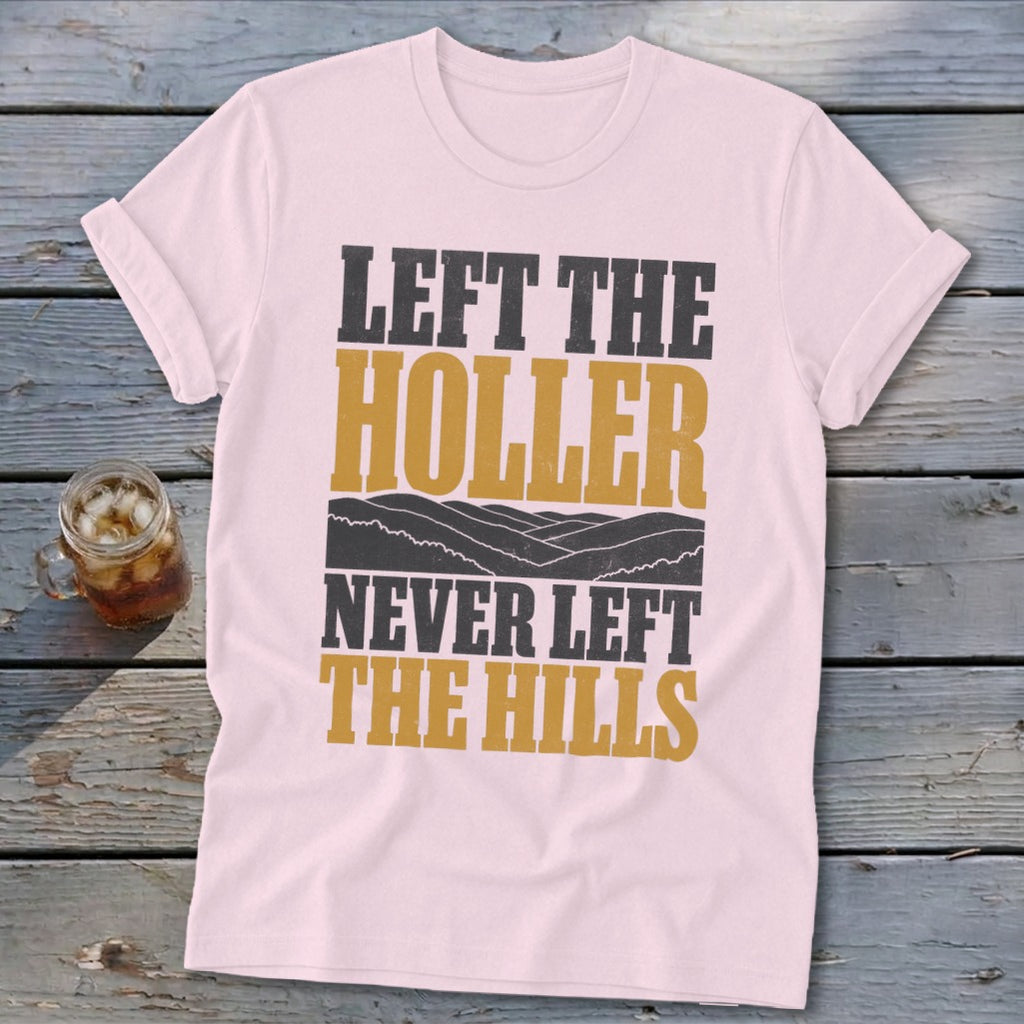 Light pink t-shirt with text "LEFT THE HOLLER NEVER LEFT THE HILLS".