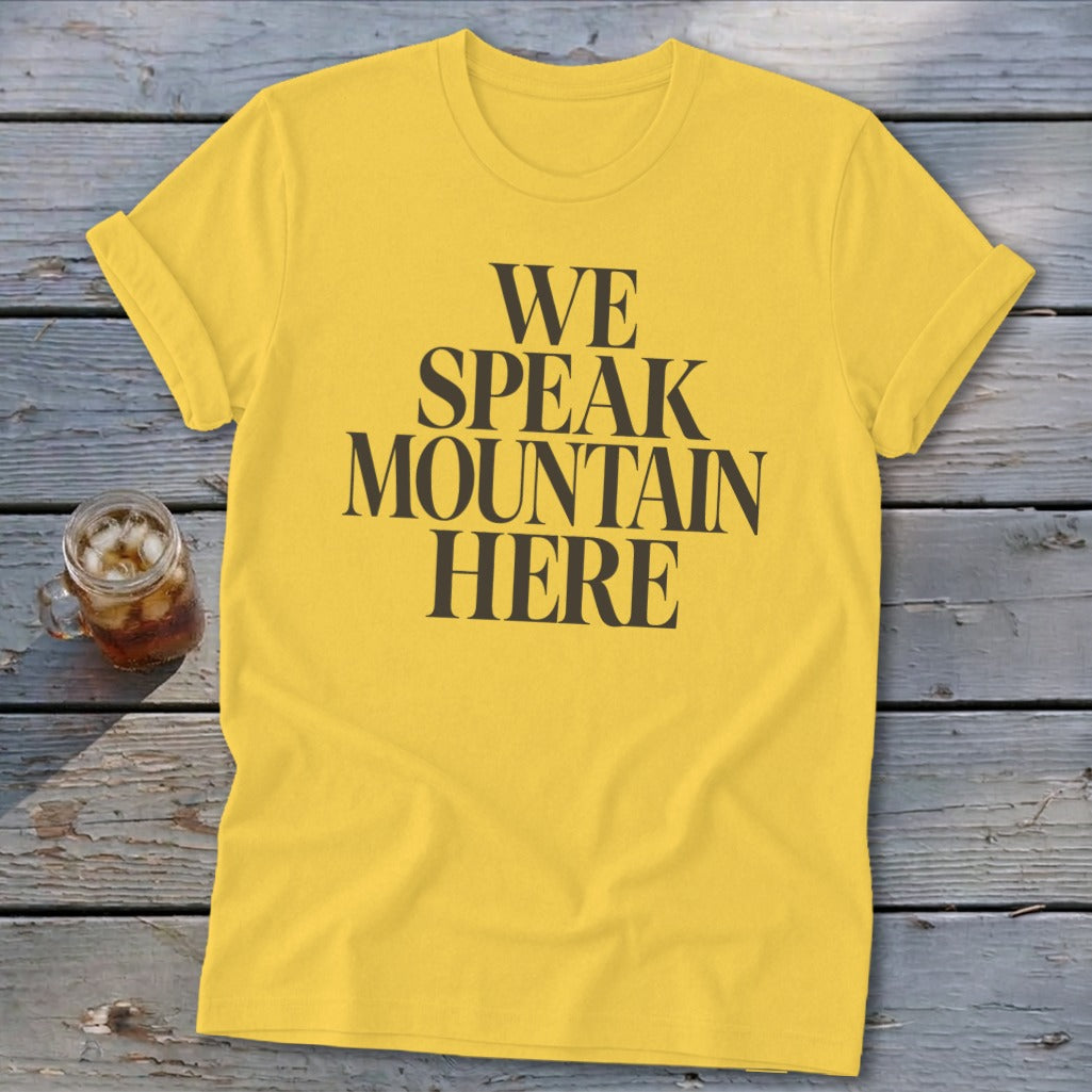 Yellow t-shirt with black text that reads "WE SPEAK MOUNTAIN HERE".