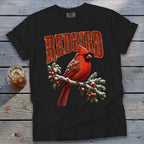 A black t-shirt features a graphic of a red cardinal on a snowy branch with the text "REDBIRD".