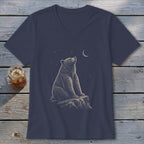 T-shirt with a graphic of a bear sitting on a rock looking at the night sky.