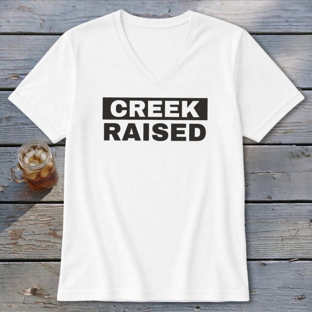 White V-neck t-shirt with black "CREEK RAISED" text in a rectangular box.