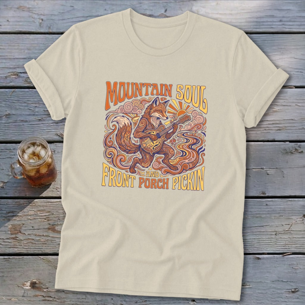 Tan t-shirt with a fox playing guitar and "Mountain Soul and Front Porch Pickin'" text.