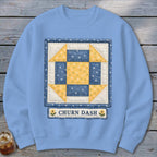 Light blue sweatshirt featuring a "Churn Dash" quilt block design with yellow flowers.