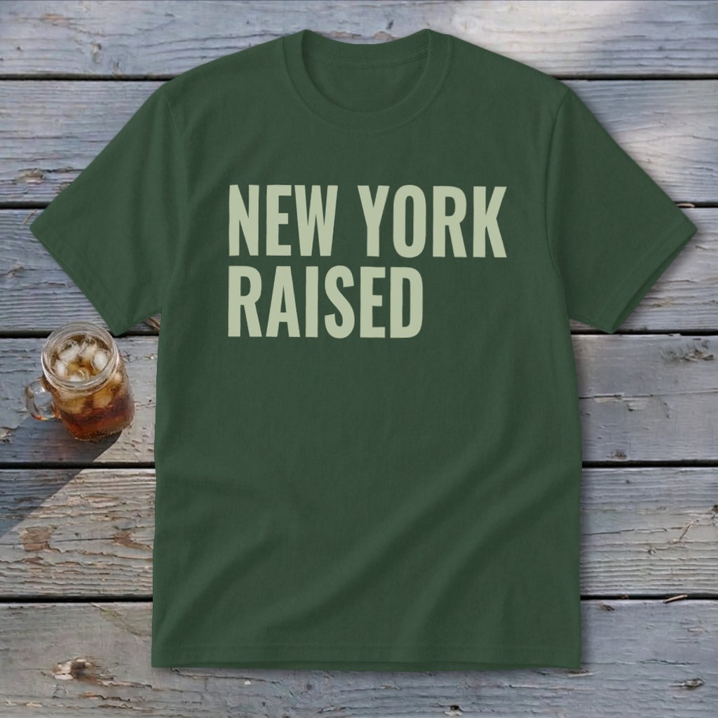 Green t-shirt with "NEW YORK RAISED" printed in light cream text.