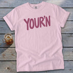 Pink t-shirt with "YOUR'N" graphic and a drink in a mason jar.