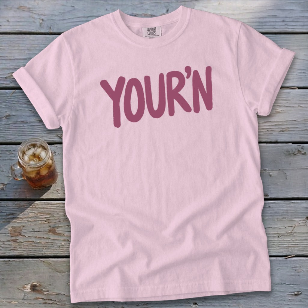 Pink t-shirt with "YOUR'N" graphic and a drink in a mason jar.