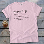 Light pink t-shirt featuring the definition of Stove Up printed on the chest, laid on weathered wood.