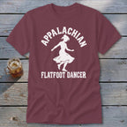 Maroon t-shirt featuring a white silhouette of a woman dancing and the text "Appalachian Flatfoot Dancer".