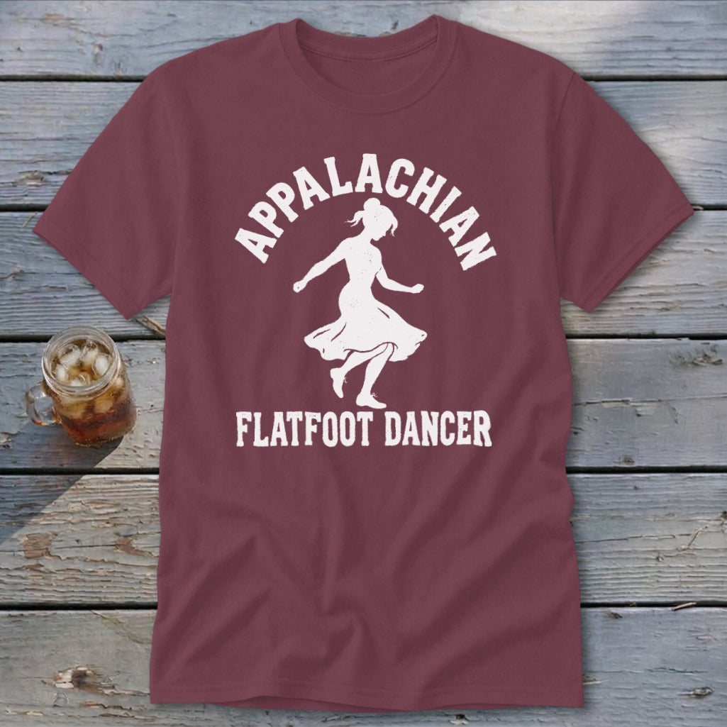 Maroon t-shirt featuring a white silhouette of a woman dancing and the text "Appalachian Flatfoot Dancer".