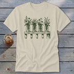 A cream-colored short-sleeved t-shirt features a green graphic of four mason jars filled with wildflowers on a shelf.