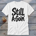 A white short-sleeved t-shirt with the black text Still A-Goin' printed across the front.