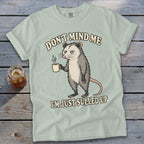 Light green t-shirt with an opossum holding coffee and text "DON'T MIND ME I'M JUST SULLED UP".
