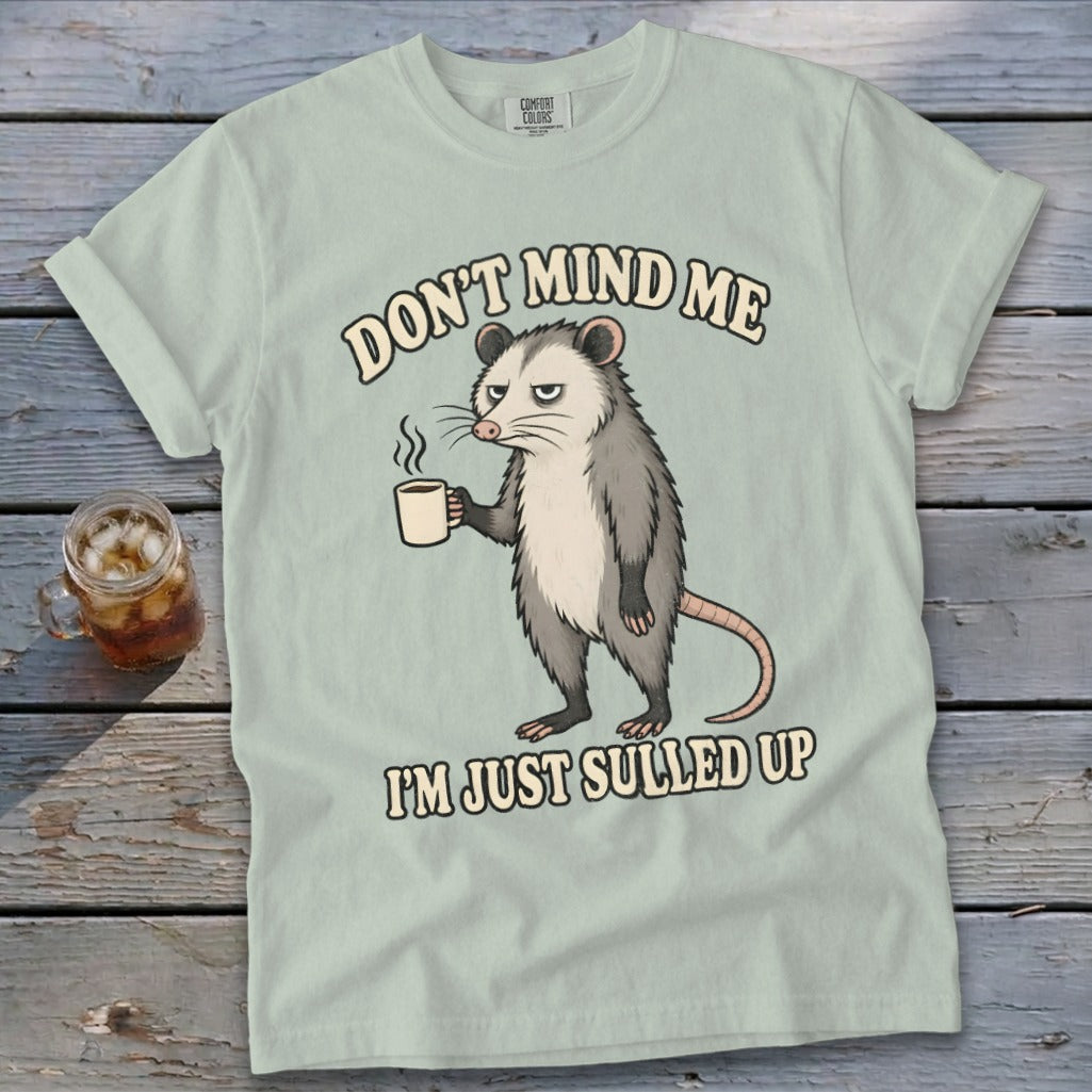 Light green t-shirt with an opossum holding coffee and text "DON'T MIND ME I'M JUST SULLED UP".
