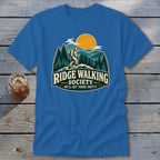 Blue t-shirt with Ridge Walking Society graphic featuring a hiker in mountains.