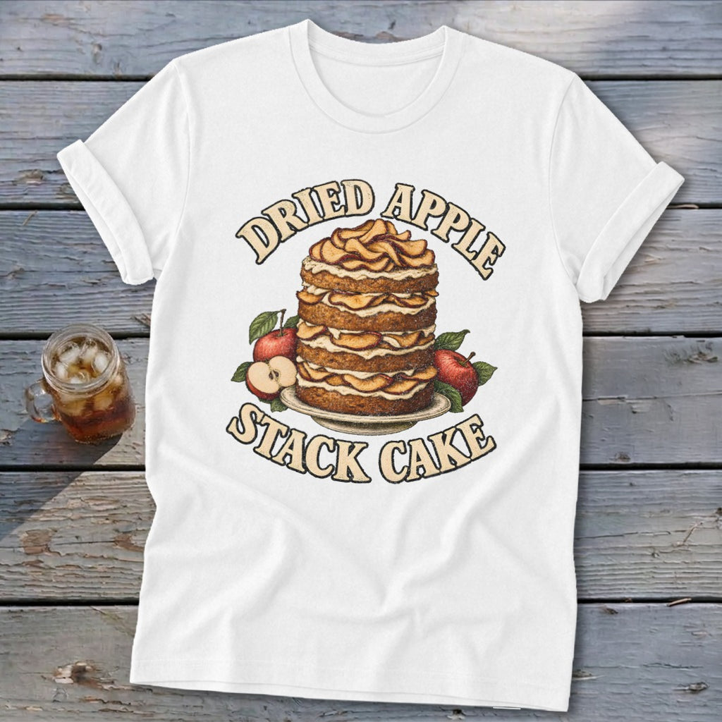 White t-shirt graphic of a layered dried apple stack cake with surrounding apples.