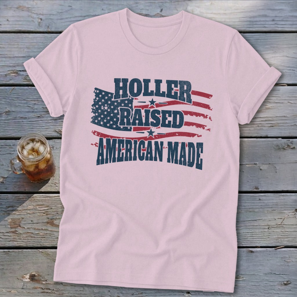 Pink t-shirt with American flag graphic and "Holler Raised American Made" text.