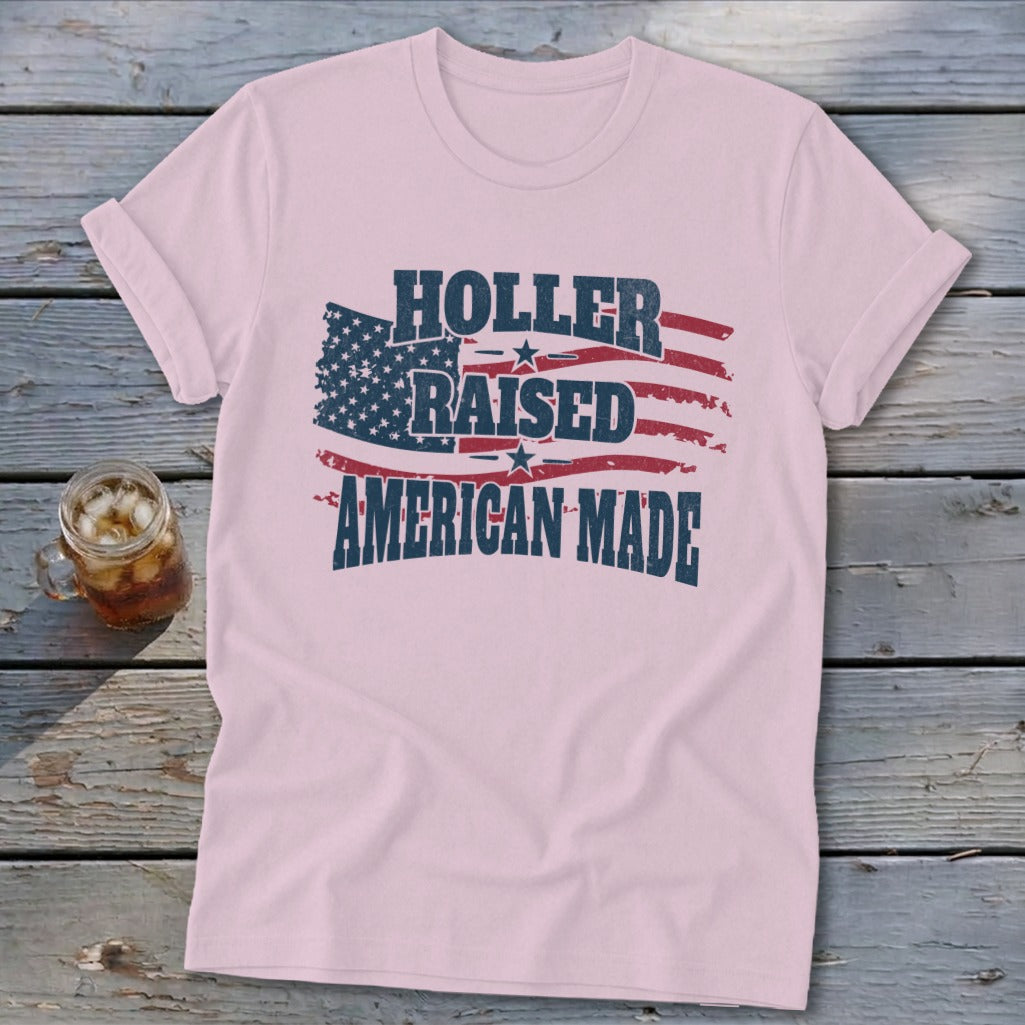 Pink t-shirt with American flag graphic and "Holler Raised American Made" text.