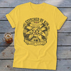 Yellow t-shirt with "Stitched by Kin" and "Every Square Tells a Story" text.