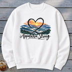 White sweatshirt with a heart-shaped graphic of rolling mountains and "Appalachia Strong" text.