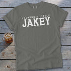 Grey t-shirt with white text "LOOKING A LITTLE JAKEY" and a glass of iced tea.