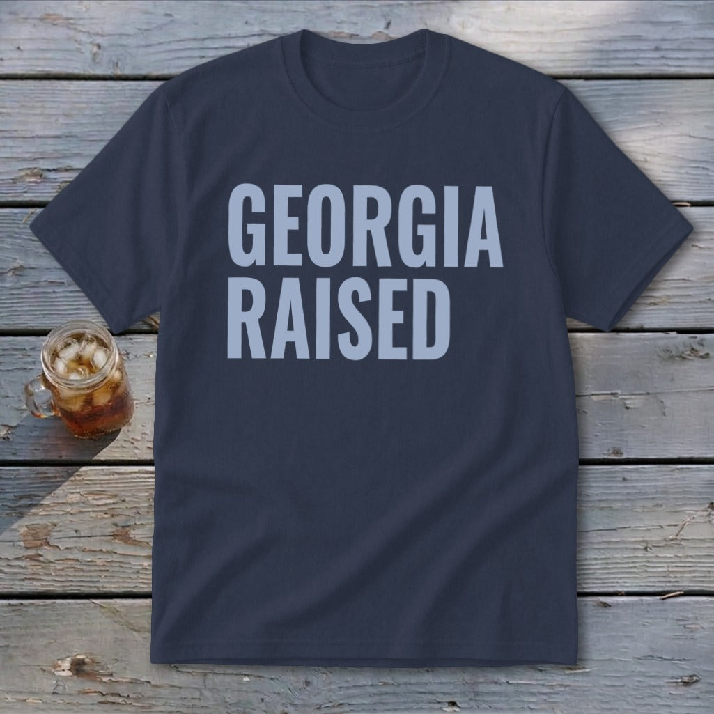 Navy t-shirt with "GEORGIA RAISED" in light blue text.