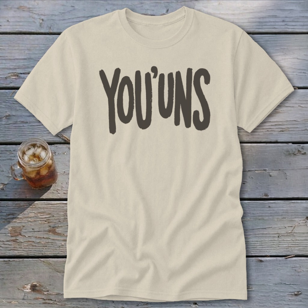 Cream t-shirt with dark gray "YOU'UNS" text and a glass of iced tea.
