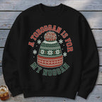 A black crewneck sweatshirt featuring a graphic of a winter knit hat surrounded by snowflakes and the text A TOBOGGAN IS FOR MY NOGGAN.