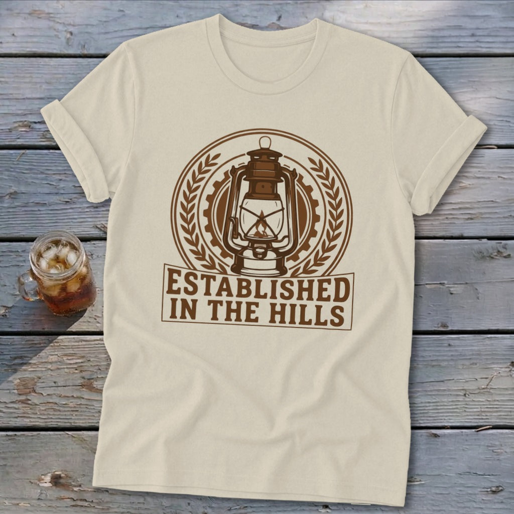 Cream t-shirt with brown lantern emblem and "Established In The Hills" text.