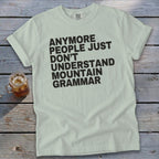 Light green t-shirt with black text reading "Anymore people just don't understand mountain grammar".