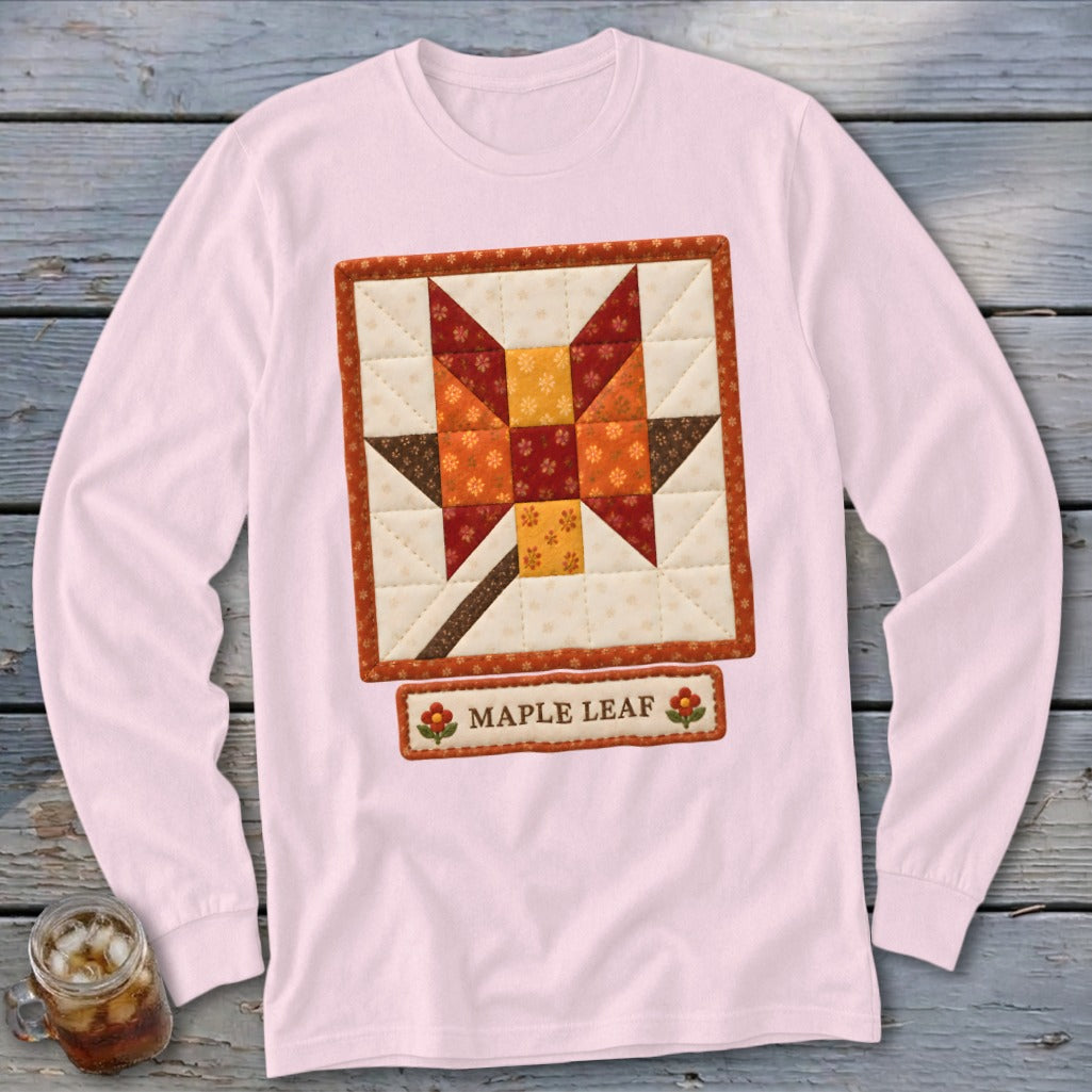 Pink long-sleeve shirt with a square quilted maple leaf design and "Maple Leaf" text.