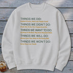 White sweatshirt with text listing "Things We Did" and other categories.