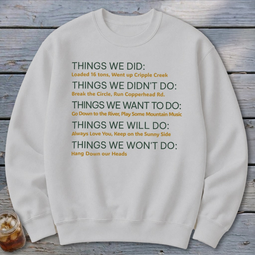 White sweatshirt with text listing "Things We Did" and other categories.