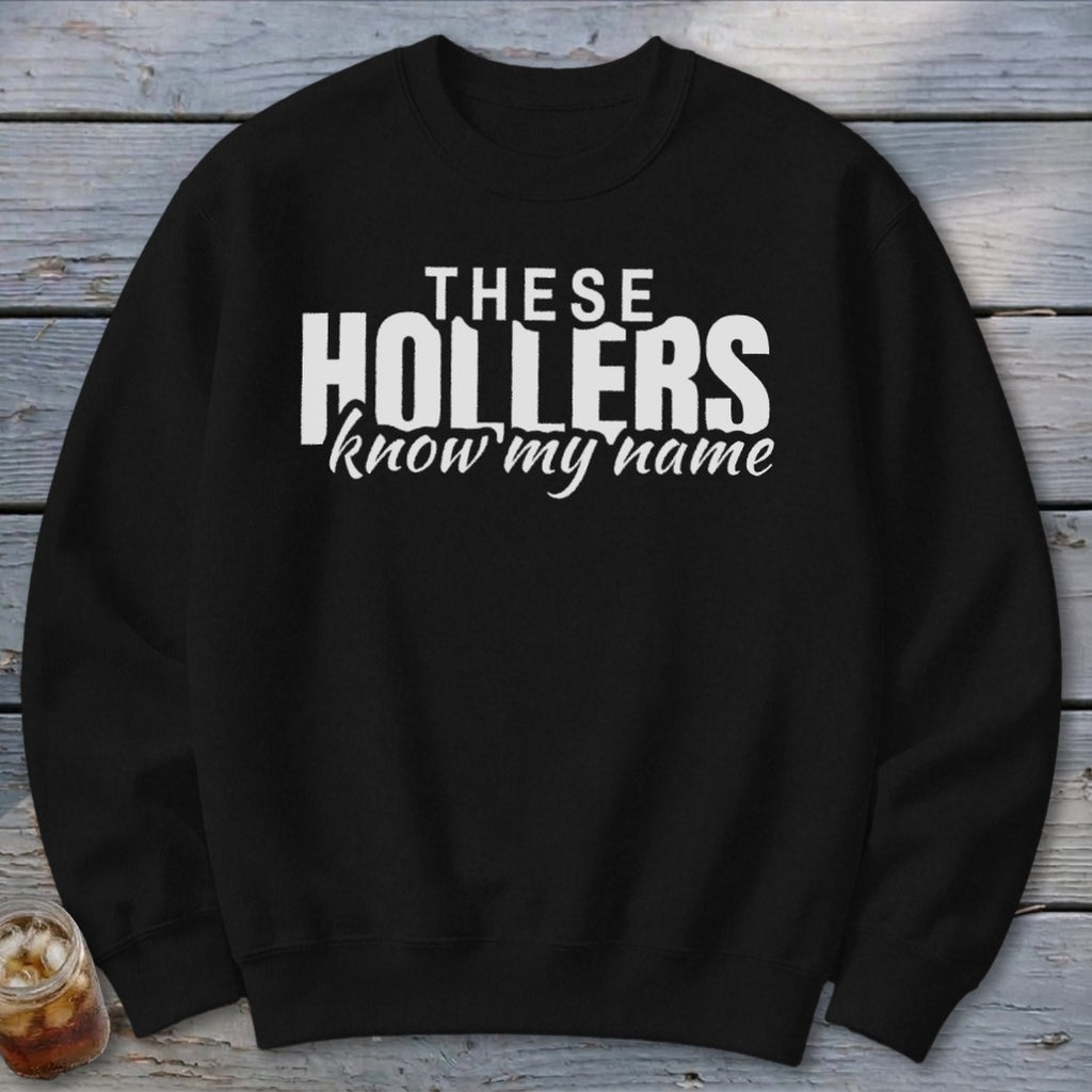 Black sweatshirt with white text "THESE HOLLERS know my name".