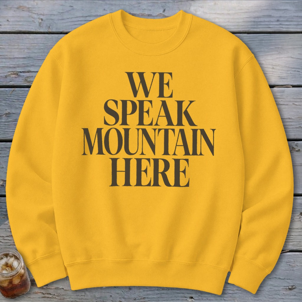 Yellow sweatshirt with "WE SPEAK MOUNTAIN HERE" text in black.