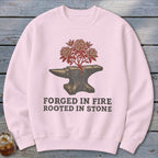 Pink sweatshirt with an anvil and flowering branches graphic and text.