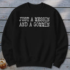 Black crewneck sweatshirt with white text "JUST A MESSIN AND A GOMMIN".
