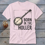 Pink t-shirt with banjo graphic and text "BORN IN THE HOLLER".
