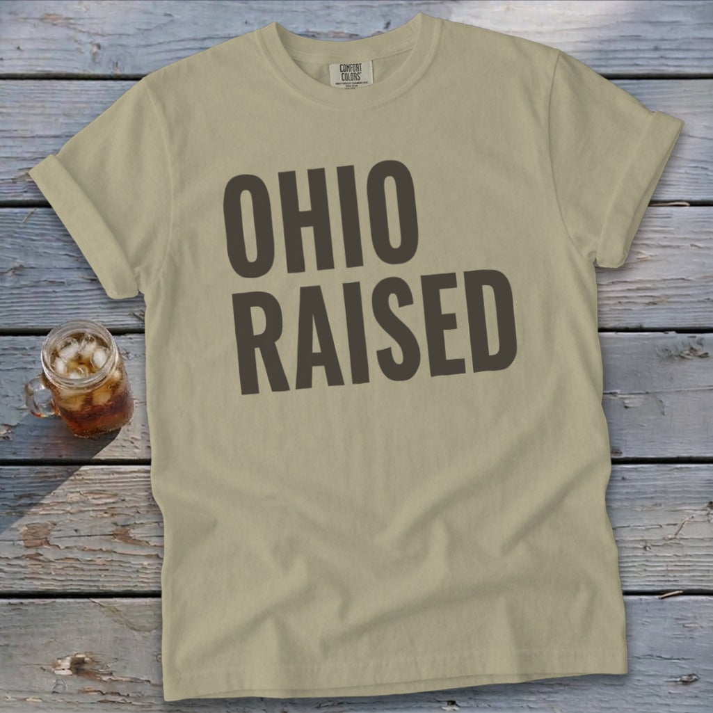 Tan t-shirt with large dark gray text reading "OHIO RAISED".