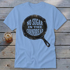 Light blue t-shirt with "No Sugar In The Cornbread" text inside a cast iron skillet graphic.