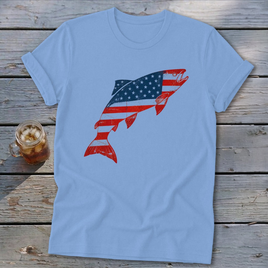 A light blue t-shirt featuring a leaping fish graphic with the American flag pattern.