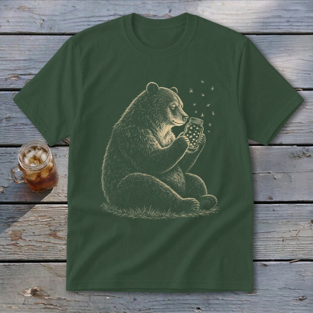 Bear holding jar with fireflies against dark green t-shirt.